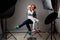 Photographing children in professional photo studio withÂ lighting equipment